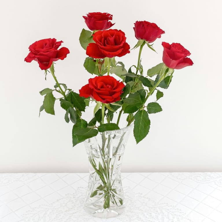 Six red roses in a cut-glass vase